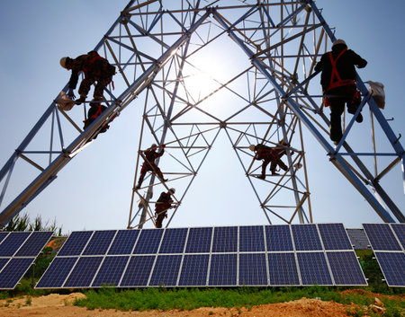 A worker at the solar panels and electric tower maintenance, energy savingのeditorial素材