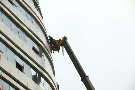 Construction workers in mobile hydraulic construction platformのeditorial素材