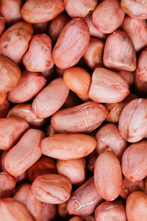 Peeled peanut kernels isolated on a white background, shot up close