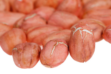 Peeled peanut kernels isolated on a white background, shot up close