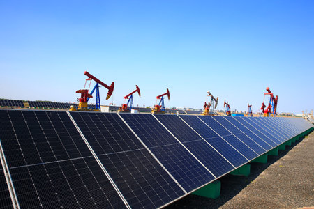 Oil pump, natural gas processing plant, with wind turbine, solar panel, industrial concept, energy saving.の写真素材
