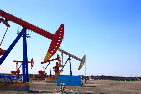 Oil pump, natural gas processing plant, with wind turbine, solar panel, industrial concept, energy saving.の写真素材