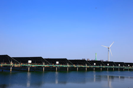 The power plant has rows of solar photovoltaic panels for producing clean electricity. The concept...