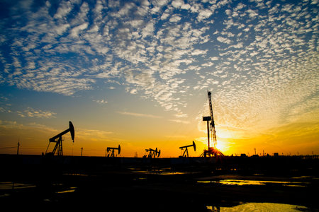 The oil pump, industrial equipment. Oil field site, oil pumps are running, Extraction of oil.の写真素材