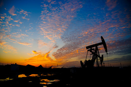 The oil pump, industrial equipment. Oil field site, oil pumps are running, Extraction of oil.の写真素材