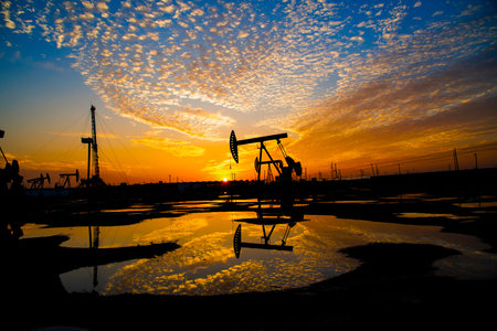 The oil pump, industrial equipment. Oil field site, oil pumps are running, Extraction of oil.の写真素材