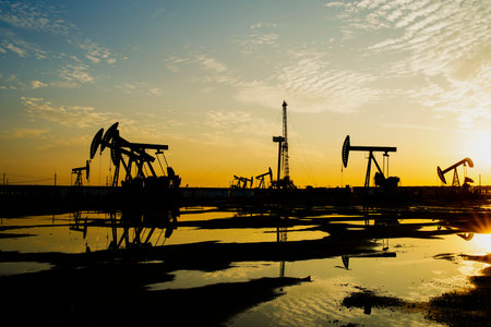 The oil pump, industrial equipment. Oil field site, oil pumps are running, Extraction of oil.の写真素材