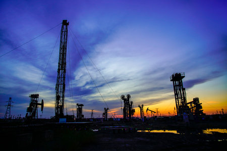 The oil pump, industrial equipment. Oil field site, oil pumps are running, Extraction of oil.の写真素材