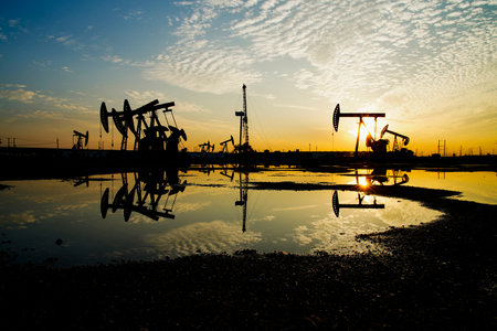 The oil pump, industrial equipment. Oil field site, oil pumps are running, Extraction of oil.の写真素材