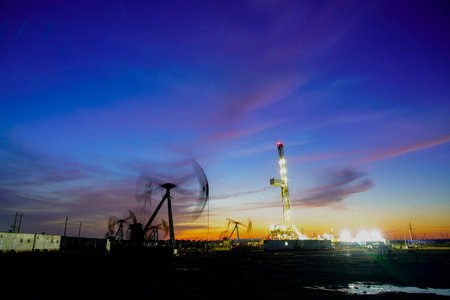 The oil pump, industrial equipment. Oil field site, oil pumps are running, Extraction of oil.の写真素材