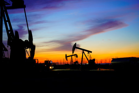 The oil pump, industrial equipment. Oil field site, oil pumps are running, Extraction of oil.の写真素材