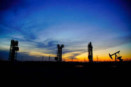 The oil pump, industrial equipment. Oil field site, oil pumps are running, Extraction of oil.の写真素材