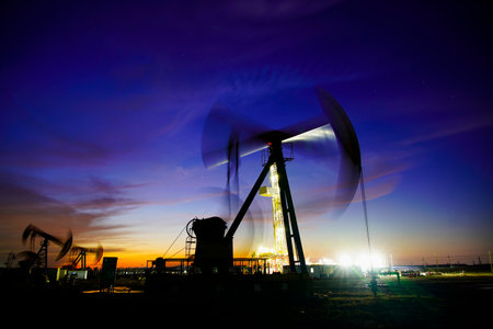 The oil pump, industrial equipment. Oil field site, oil pumps are running, Extraction of oil.