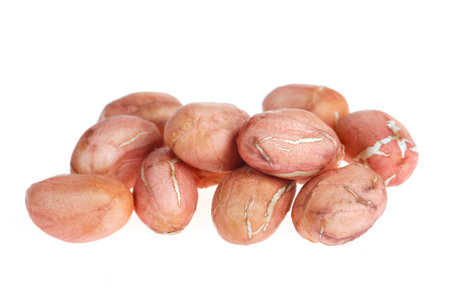 Peeled peanut kernels isolated on a white background, shot up close