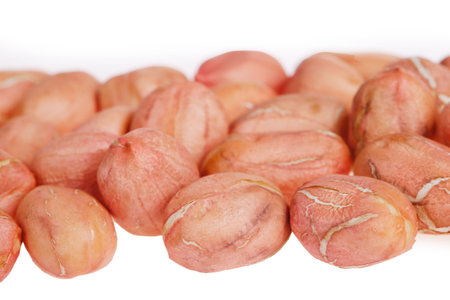 Peeled peanut kernels isolated on a white background, shot up close