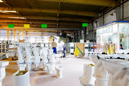 The workers are processing the ceramic bathroom production line in the production workshop.の写真素材