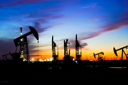 The oil pump, industrial equipment. Oil field site, oil pumps are running, Extraction of oil.の写真素材