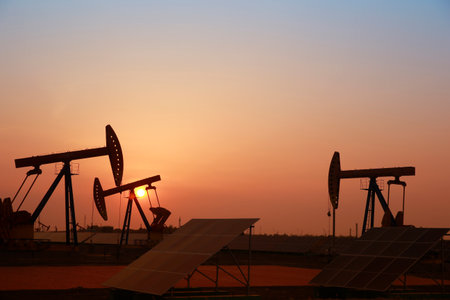 Oil pumps and solar panels, industrial equipmentの写真素材