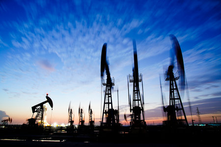 The oil pump, industrial equipment. Oil field site, oil pumps are running, Extraction of oil.