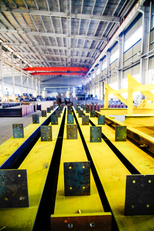 Steel structure processing in heavy industry factory, production line of metal components in factory...