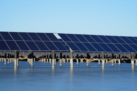 The power plant has rows of solar photovoltaic panels for producing clean electricity. The concept...