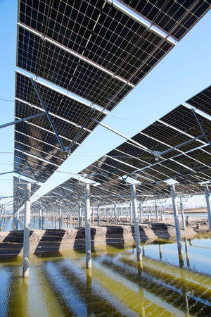 The power plant has rows of solar photovoltaic panels for producing clean electricity. The concept...