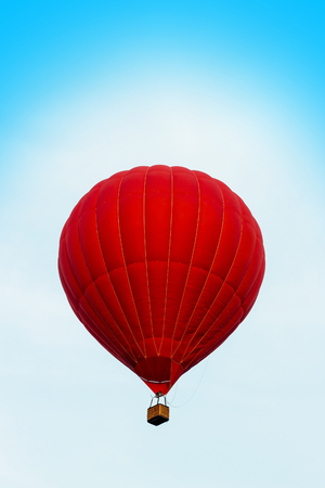 Red hot air ballon in the blue sky, close-upの写真素材