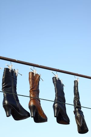 women's boots hanging in the airの写真素材
