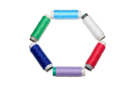 close up of color thread spool in white background