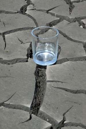 a transparent glass in the dry land, close-up, dry to the extreme, calling people to conserve water, protect the environment, Tangshan City, Hebei Province, China. の写真素材