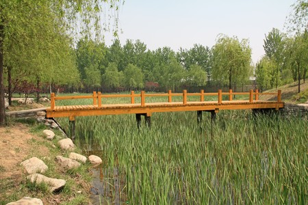 wood bridge in a park in spring, TangShang, HeBei, North China.の写真素材