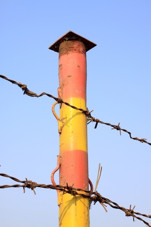 barbed wire fence on the water surfaceの写真素材