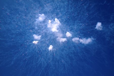 flash and white smoke in the blue sky 