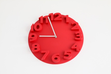 red clocks in on a white background の写真素材
