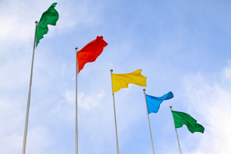 all sorts of color flags in blue sky