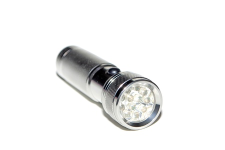 metal flashlight in white background 