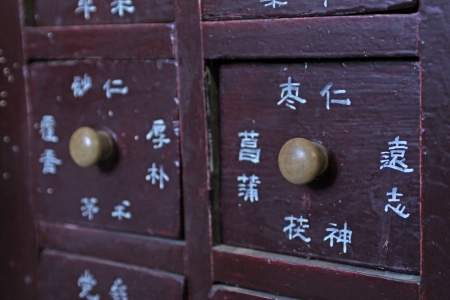 drawers full of chinese herbal medicine in a pharmacyの写真素材