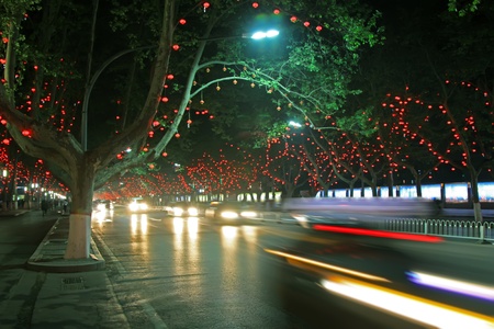 vehicles and light, trees in the modern city, in the night, north chinaの写真素材
