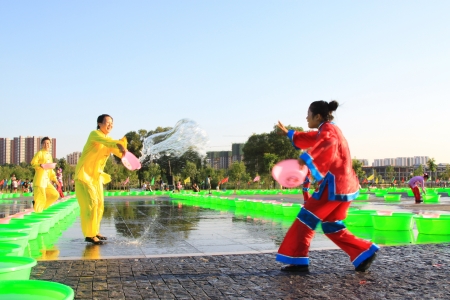 Luannan August 21  July 7th day eve, Several girls splashing water to play in the square, Luannan, Hebei, China のeditorial素材