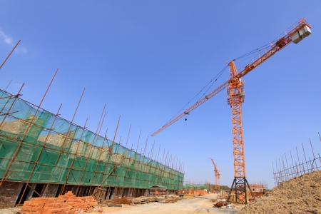 tower crane and unfinished building under the blue sky, in a building site, Chinaのeditorial素材