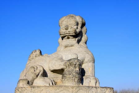 Stone lion sculptures in seventeen holes bridge railing in the Summer Palace, Beijing, chinaのeditorial素材