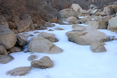 frozen stream in winter, in Field of flowers Valley mountainous area, in Hebei Province, Chinaの写真素材