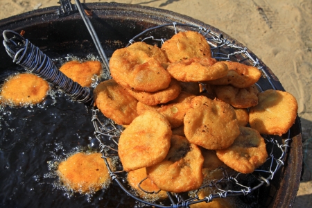 fried rice cake above the oil pan, closeup of delicacyの写真素材