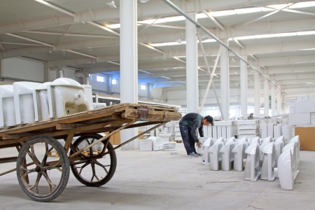 Luannan County, Hebei Province, November 17  Porter carrying ceramic toilet in the workshop in Hebei ZhongTong ceramic company  Hebei ZhongTong ceramic company is the largest local sanitary ceramics manufacturers のeditorial素材