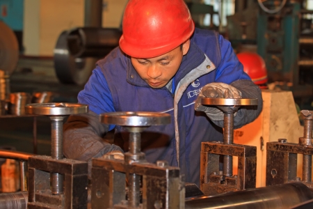 Luannan, November 19  A worker operating the machine, in Huifeng Steel Corp workshop, in November 19, 2012  Huifeng Steel Corp specializing in the production of hot rolled strip, is the largest local refined steel manufacturers のeditorial素材