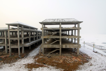 The unfinished building in the snow, in the long winter, Chinaのeditorial素材