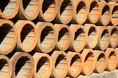 clay drain pipe stacked together in a warehouseの写真素材