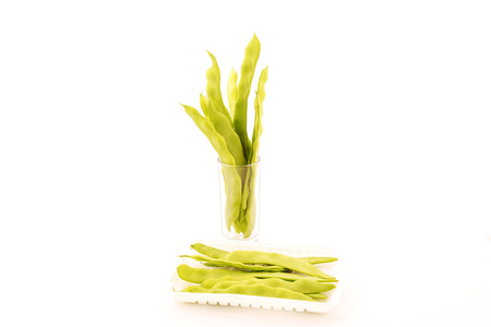 fresh beans and glass cup on a white background