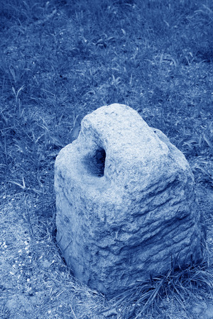 broken stone lock in the grass, closeup of photo