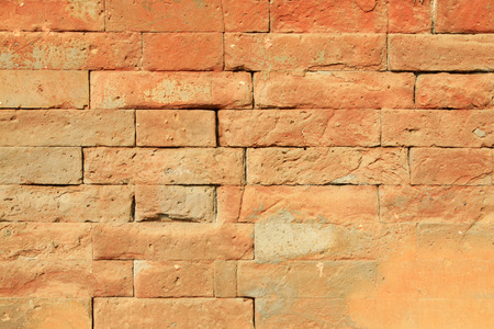broken red walls in a building, closeup of photo